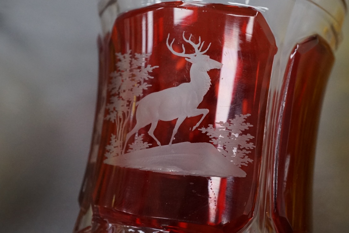Four Bohemian engraved amber or ruby flashed ‘hunting’ goblets or beakers, late 19th century, tallest 15cm high